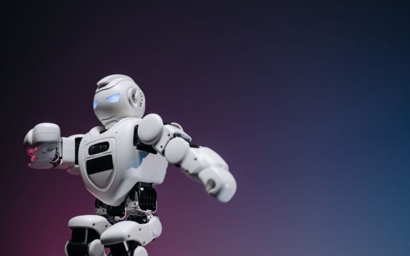 Close-up of a futuristic robotic toy against a gradient background, symbolizing innovation and technology.
