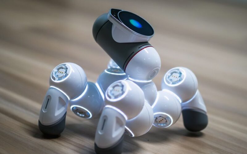 Close-up of a futuristic robot toy on a wooden floor, showcasing modern innovation.
