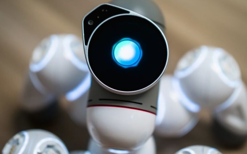Detailed close-up shot of a futuristic toy robot with a glowing head, focused on innovation.