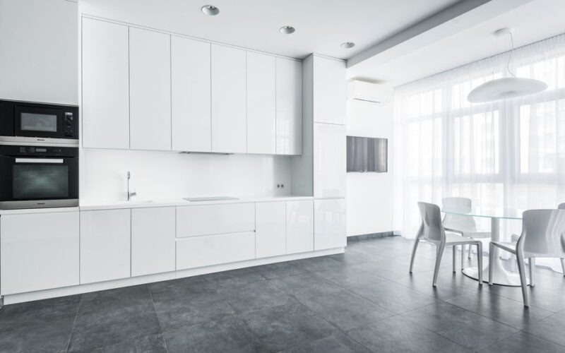 Sleek white kitchen with modern appliances and minimalist design.
