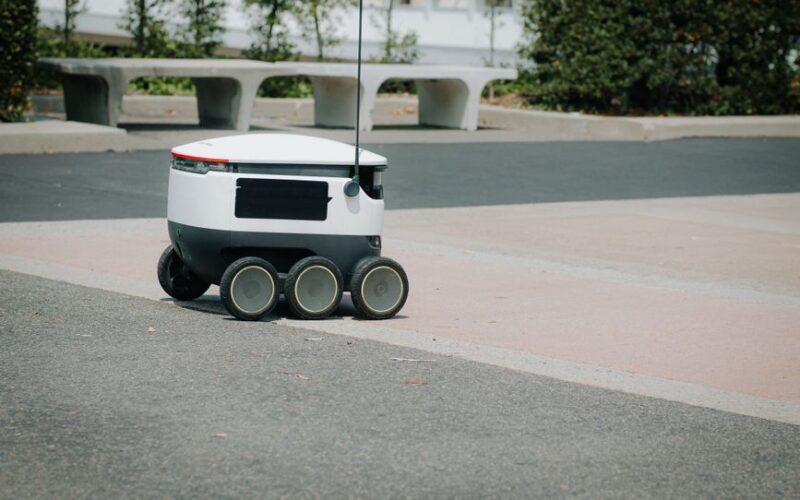A modern autonomous delivery robot navigating an urban environment. Innovative technology for food delivery.