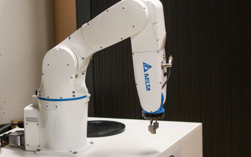 Close-up of a Delta brand robotic arm in an industrial setting, showcasing automation technology.