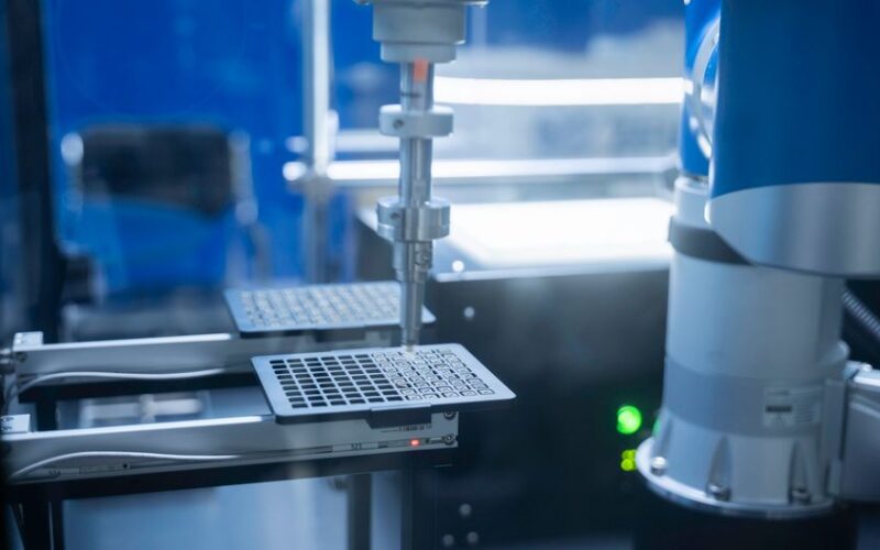 Close-up of robotic arm automating lab processes with precision.