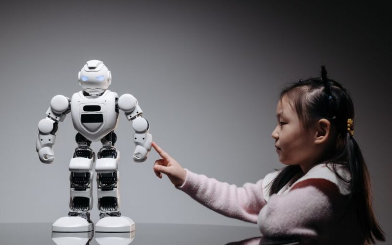 A young girl engaging with a robotic toy, highlighting curiosity and innovation.