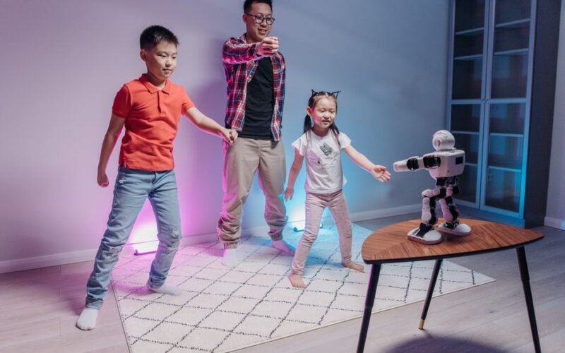 Family bonding with a robot in a living room, kids and adult in playful interaction.