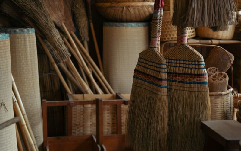 Capture of traditional Japanese brooms and baskets displayed indoors in Tokyo.