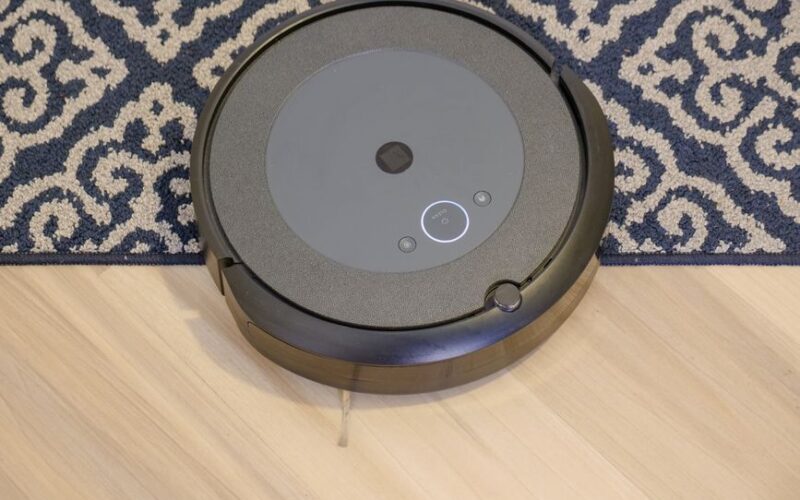 Modern robotic vacuum cleaner on a patterned carpet for efficient cleaning.