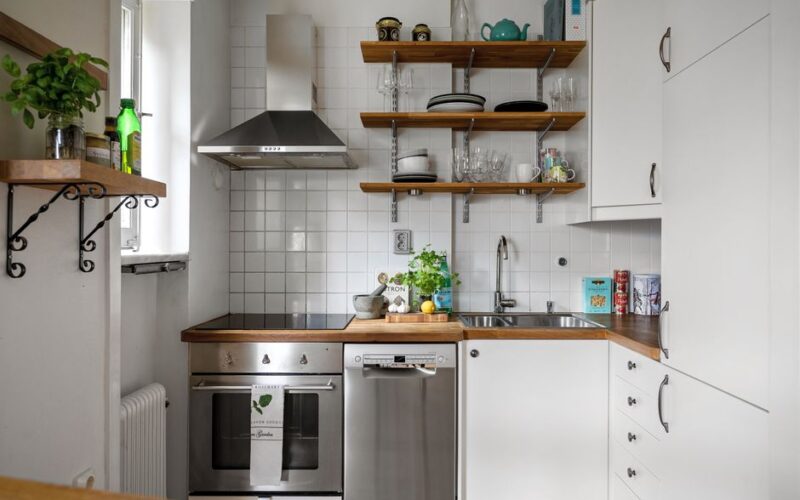Contemporary small kitchen featuring stainless steel appliances and open shelving.