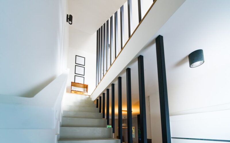 Brightly lit modern interior staircase with clean lines and minimalist decor.