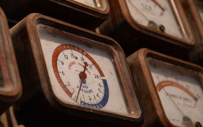 Close-up of a collection of vintage vacuum gauges with a rusty, nostalgic appearance.