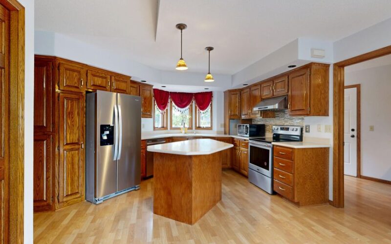 Beautiful kitchen with wooden cabinets, center island, and stainless steel appliances.