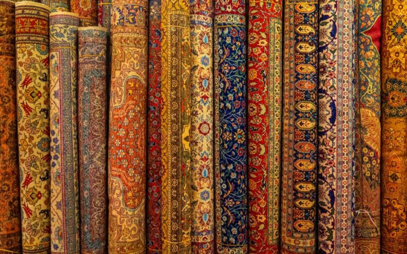 A vibrant collection of traditional Persian rugs with intricate designs and rich colors.