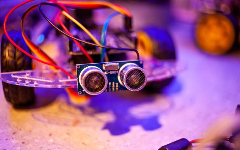 Detailed view of a robotic vehicle component showcasing wires and sensors.