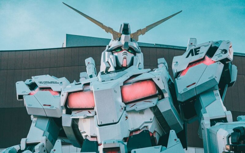 Striking view of a giant robot sculpture with vibrant LED accents in an urban setting.